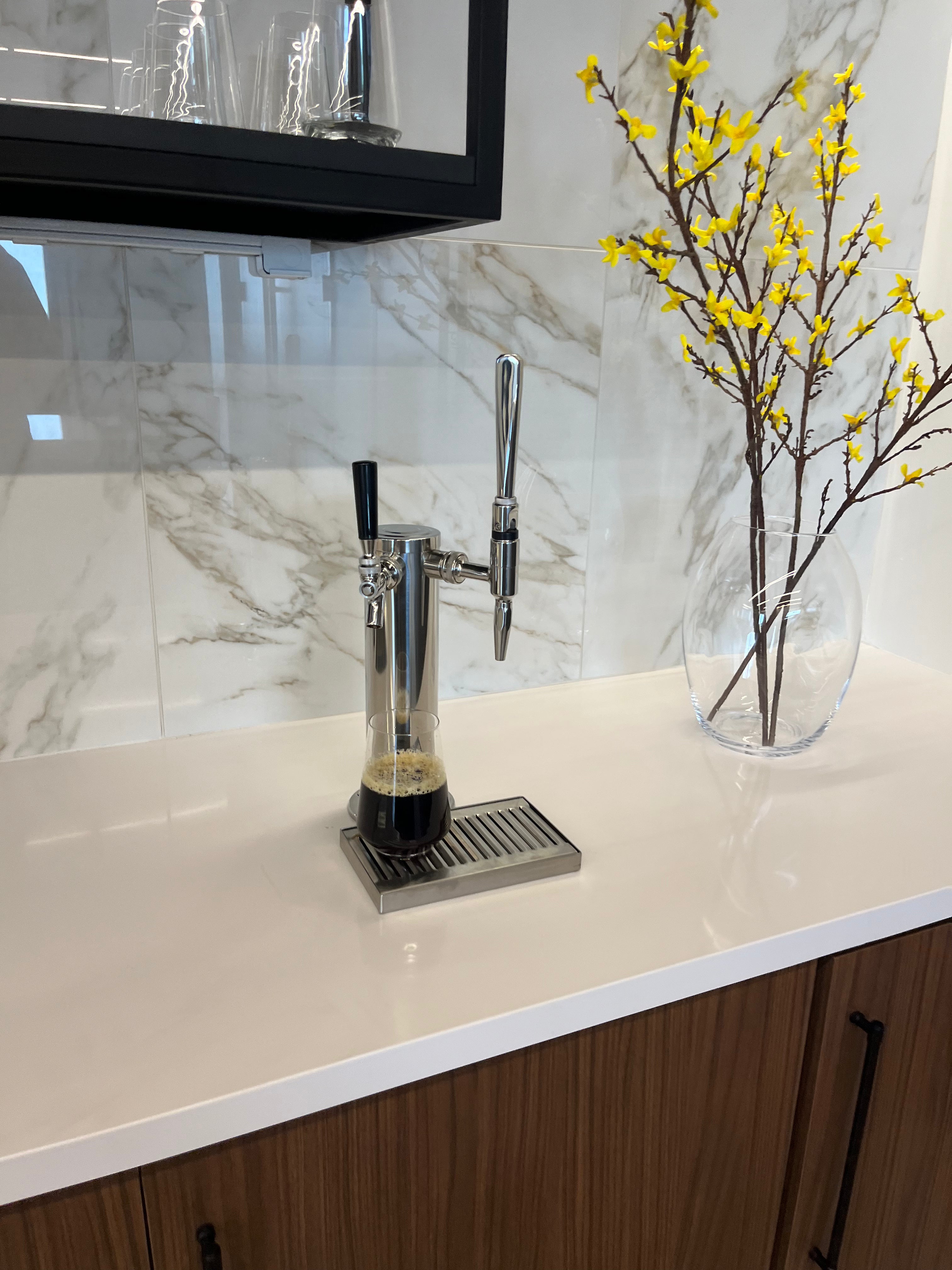 glass of cold brew from tap system and keg of cold brew coffee