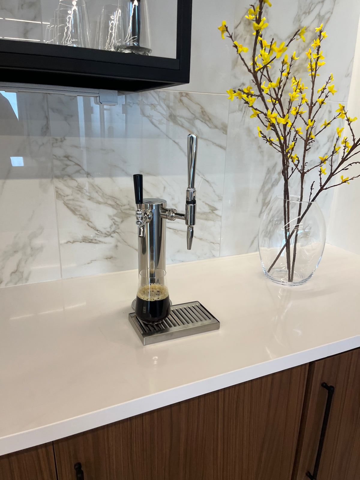 glass of cold brew from tap system and keg of cold brew coffee