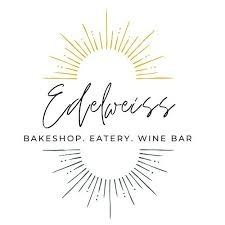 Logo of Edelweiss Bakeshop, Eatery, Wine Bar with sunburst design